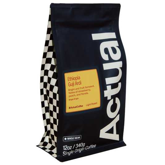 A bag of Actual Coffee Ethiopia Guji Ardii whole bean single origin coffee. The bag is dark navy blue with a large white vertical 'Actual' logo, a yellow label with black text, and a black and white checkered pattern on the left side.